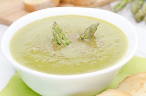 cream soup of asparagus and green peas close-up horizontal
