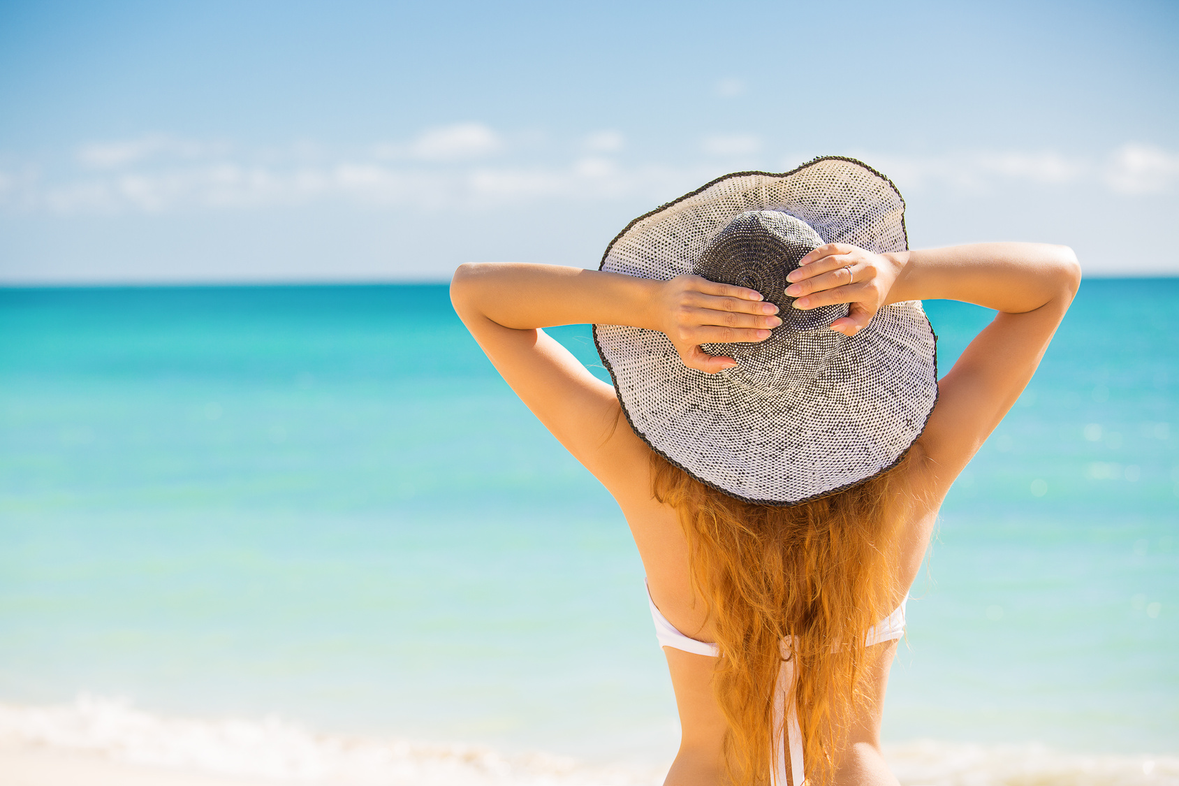 Woman enjoying beach relaxing joyful in summer by tropical ocean